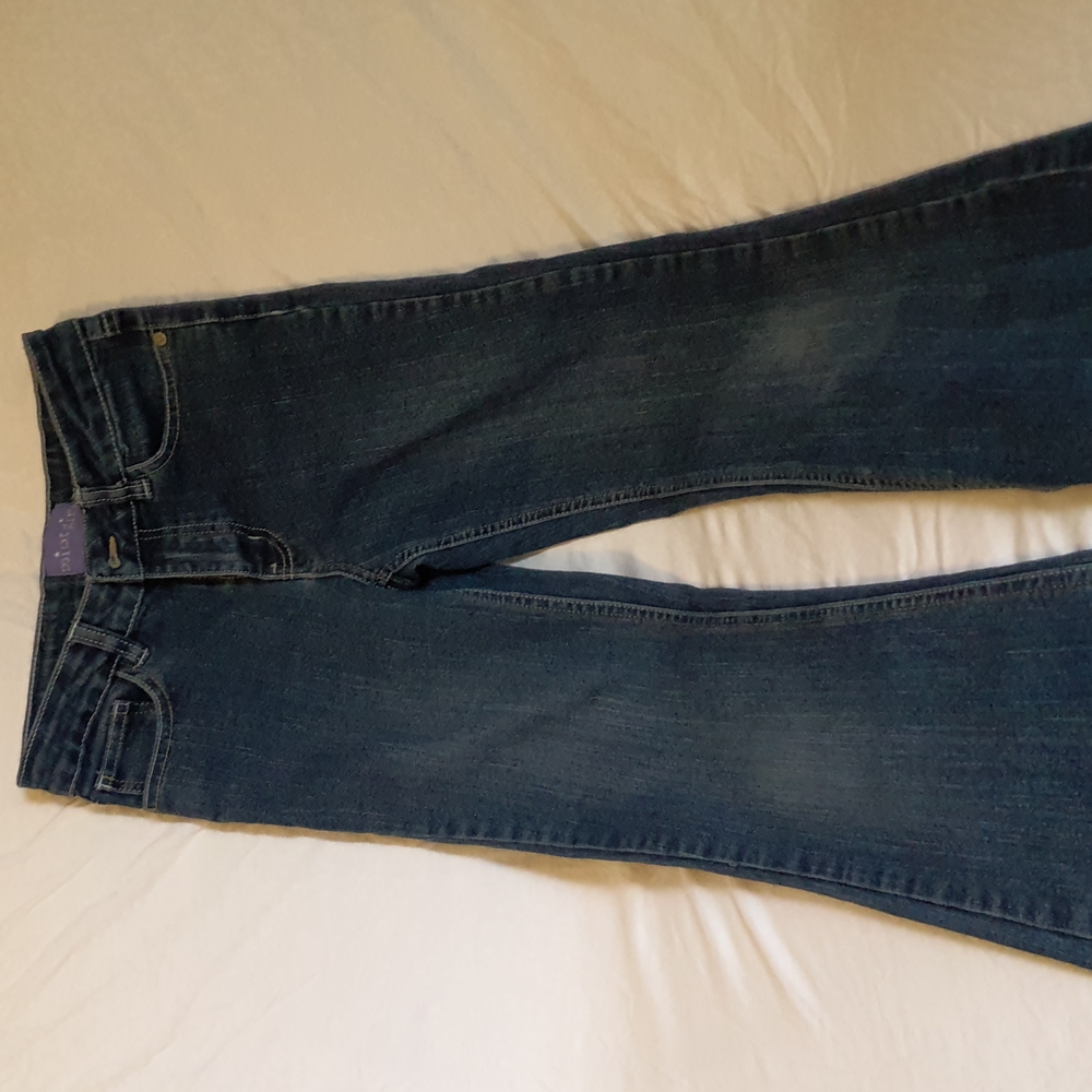 Blue jeans w/ black and teal design on back pocket